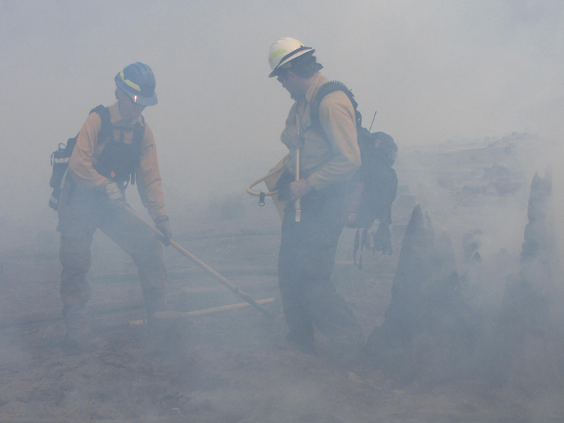 firefighters working in smokey haze 